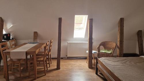 a dining room with a wooden table and chairs at Studio Rasnov Apartaments in Râşnov