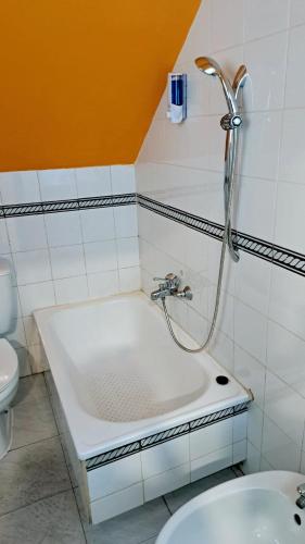a bathroom with a bath tub and a toilet at Arc House Plaza in Seville