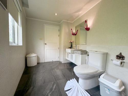 a bathroom with a toilet and a sink at At Pingnakorn Nimman Hotel in Chiang Mai
