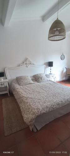 a bedroom with a white bed and a lamp at Villa féeric in Toulon