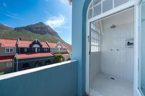 an open window with a view of a house at 'Imagine' - Surfers Corner Muizenberg Village in Cape Town