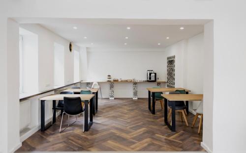 a room with tables and chairs and a counter at Hotel Cristallo in Landshut