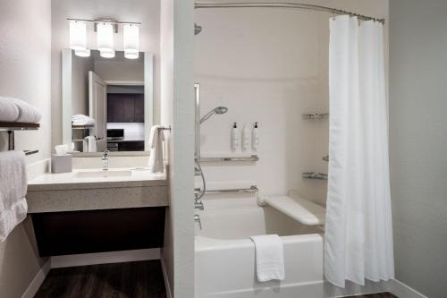 a bathroom with a tub and a sink and a shower at TownePlace Suites By Marriott Venice in Venice