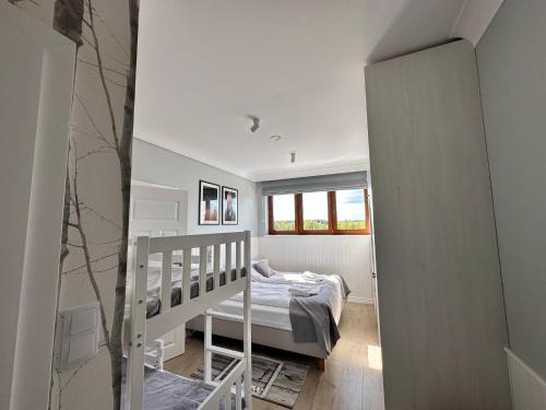 a small bedroom with a bed and a staircase at AURA Centrum Wypoczynkowo-Rekreacyjne in Sejny