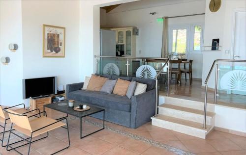 a living room with a couch and a table at Villa Olivia Greece with private pool & seaview in Sivota Lefkada in Sivota