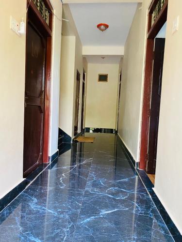 a hallway with a blue tiled floor in a building at Hotel Aagaman - Best Family Hotel in Bandipur in Bandīpur