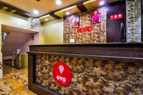 a bar with a baseball sign on the wall at OYO Flagship Dream Connect in Jamshedpur