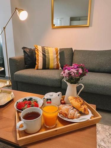 a tray with breakfast foods and coffee on a table at Golden Place-Costa da Caparica in Costa da Caparica