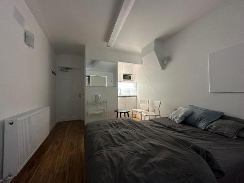 a bedroom with a bed and a table and chairs at Santry Studio in Dublin