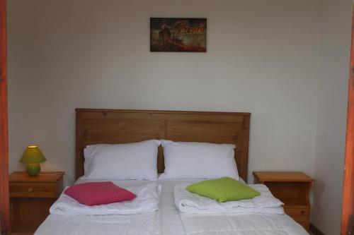 a bed with two pillows on top of it at Nikos Seaside Apartments in Litherés