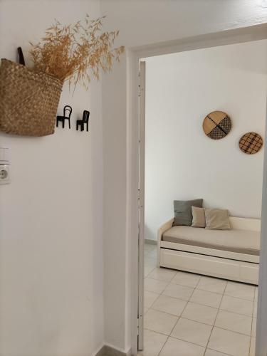 a living room with a couch and a mirror at Galini Rooms & Apartments in Finikas