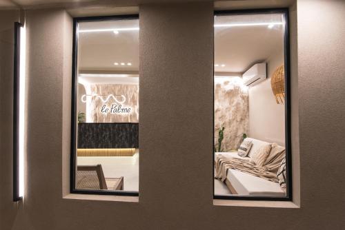 a reflection of a living room in a mirror at Le Palme in Malia