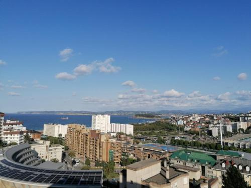 a view of a city with the ocean and buildings at El Balcón de Charles in Santander