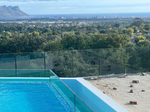 a swimming pool with a view of a city at Amazing! 7 bedroom villa with rooftop pool & views in Cape Town
