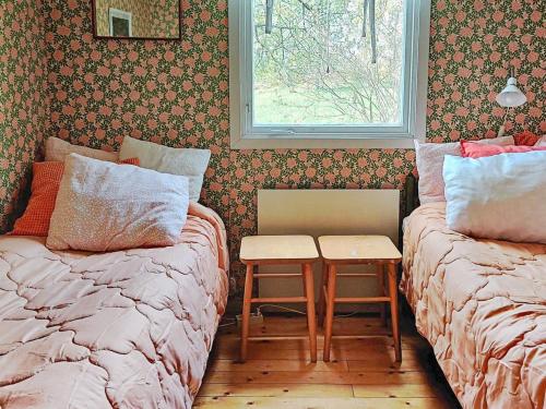 a bedroom with two beds and a window at Holiday home AXVALL in Axvall