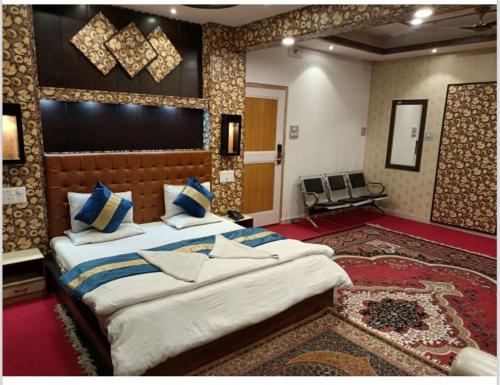a bedroom with two large beds in a room at Hotel Al-Zahoor In, Srinagar in Srinagar