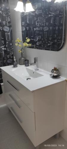 a bathroom with a white sink and a mirror at Apartamento entero en la playa san juan Benacantil in Alicante