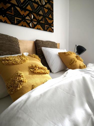 a bedroom with two beds with yellow and white pillows at Salotto Brè - Bed & Breakfast charming rooms in Lugano