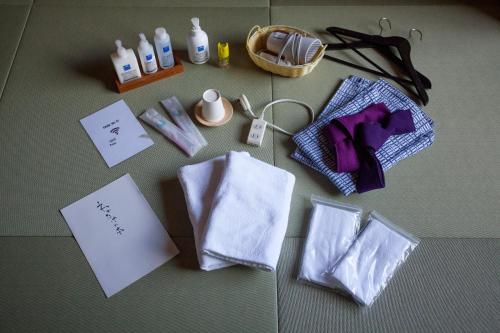 a table topped with white towels and a basket of items at Wakatake in Katsuura