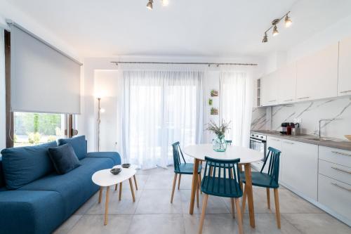 a living room with a blue couch and a table at Argilos Residential Complex in Ofrínion