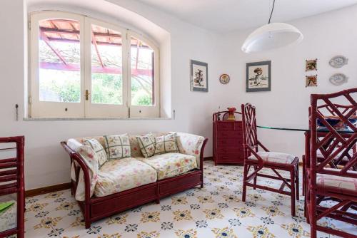 a living room with a couch and two chairs at Villa with private access to the sea in Forio D'Ischia in Ischia