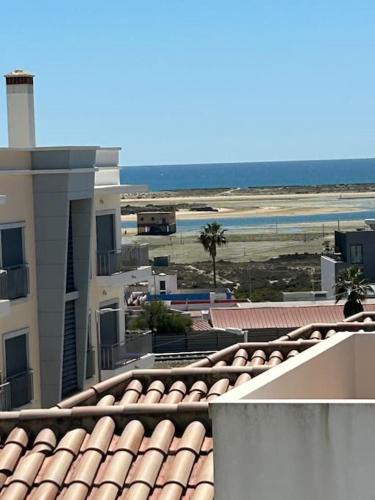 a view of the beach from the roof of a building at The Retreat Fuseta - 3 bed eco villa, own pool in Fuzeta