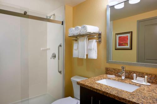 a bathroom with a sink and a toilet and a shower at TownePlace Suites by Marriott Thunder Bay in Thunder Bay