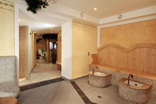 a bathroom with two sinks in the middle of a room at Pension Wendlhof in Obergurgl