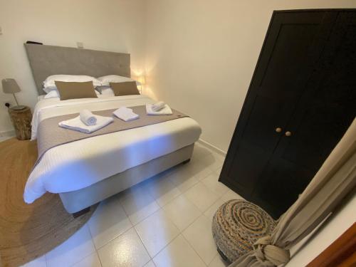 a bedroom with a large bed with towels on it at GaliniCafe22-suites in Kakopetria