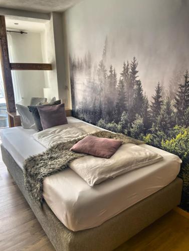 a bedroom with a bed with a painting on the wall at Hotel Nuhnetal in Winterberg