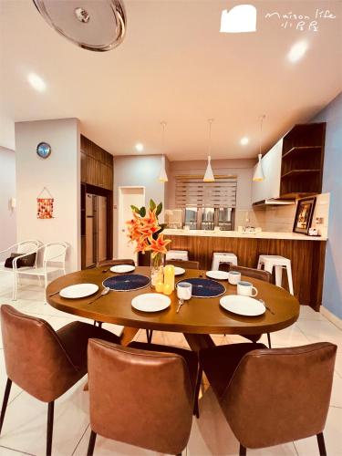 a dining room and kitchen with a wooden table and chairs at Maison life 小居屋 The Loft Imago in Kota Kinabalu