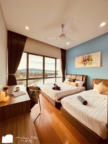 two beds in a room with a large window at Maison life 小居屋 The Loft Imago in Kota Kinabalu