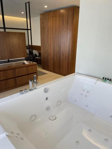 a large white bath tub in a bathroom at The Duke Boutique Hotel in Victoria