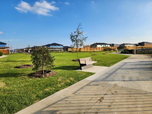 a park with a bench and a tree in the grass at Dream Family Retreat ! Escape Relax and Rejuvenate in Berwick