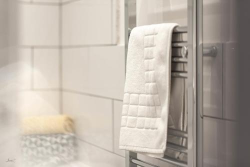 a towel hanging on a towel rack in a bathroom at Liverpool Harrow Road Sleeps 6- Infinity Apartment in Liverpool
