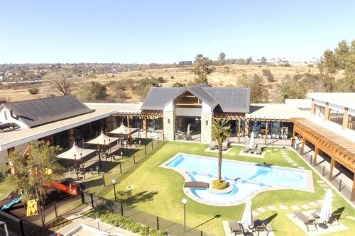 an overhead view of a building with a swimming pool at Teasa Stays - Upliving Lifestyle nearby Fourways in Northriding