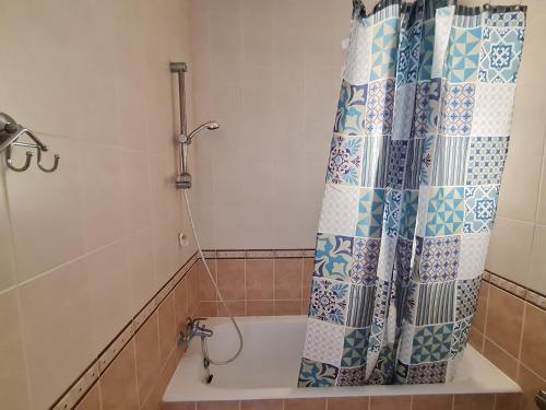 a bath tub with a shower curtain in a bathroom at Laertis 2 Complex, Studio Apartment 106 - By IMH Travel & Tours in Paphos City