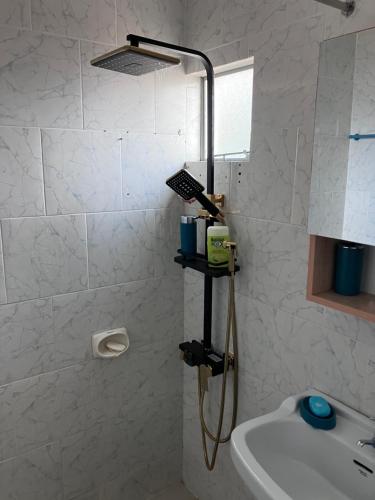 a bathroom with a shower and a sink at Safia in Trou aux Biches