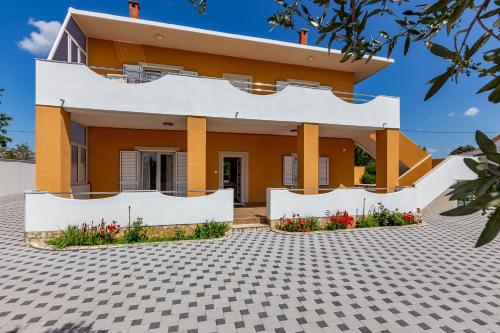 a house with white and orange at MP Luxury Holiday Home with swimming pool in Zadar