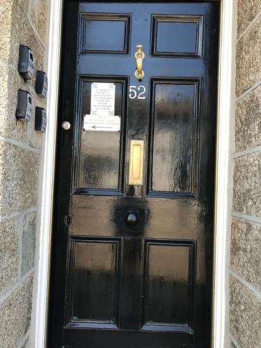 a black door with the number on it at No 52 bed and breakfast in Helston