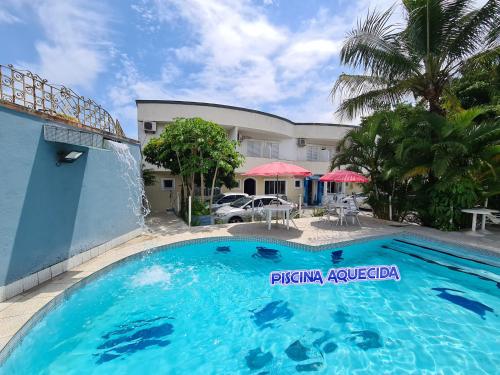 a large swimming pool in front of a building at Hotel Pousada Iracemar - Guarujá in Guarujá