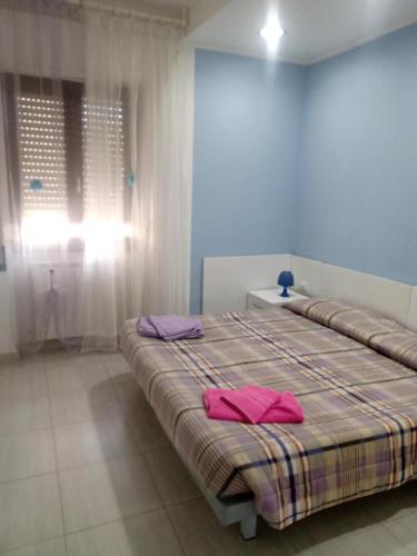 Ένα ή περισσότερα κρεβάτια σε δωμάτιο στο La Casa Dei Fiori