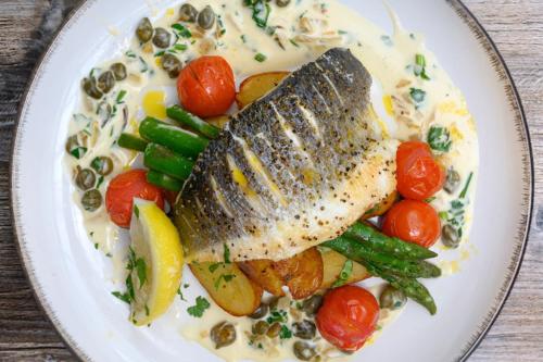 a plate of food with a fish and vegetables at The Victoria Inn in Truro