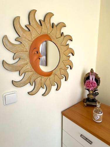 a sunburst mirror on a wall in a room at Sunny Apartment Amaliada in Amaliás