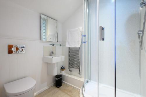 a bathroom with a shower and a toilet and a sink at The Victoria Inn in Truro