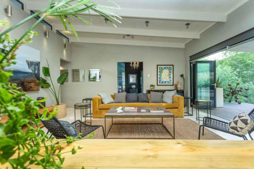 a living room with a couch and a table at Karoo Mountain River House in Calitzdorp