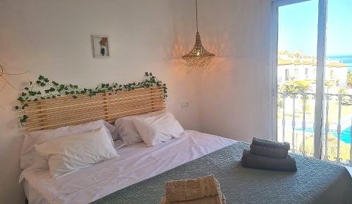 a bedroom with a large bed with areath on it at Casa-Mar Nerja in Nerja