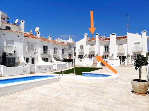a view of the courtyard of a large white building at Casa-Mar Nerja in Nerja