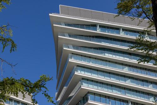 an office building with blue sky in the background at Your Holidays Waves in Międzyzdroje