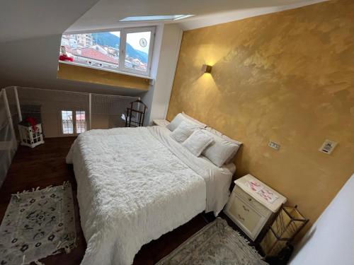 a bedroom with a large bed and a window at Casa di Adelaide in Schio